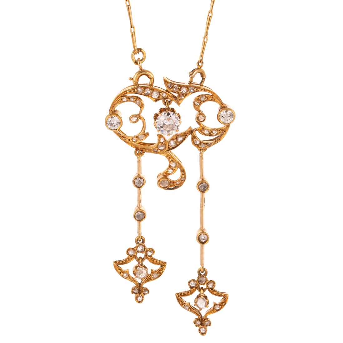 An Art Nouveau Diamond Lariat Necklace in 14K: c.1890s, 14K yellow gold scrolling lariat necklace featuring a central Old European cut diamond weighing approx. 0.45 carats with an average color grade of I - J and an average clarity grade of VS, wi