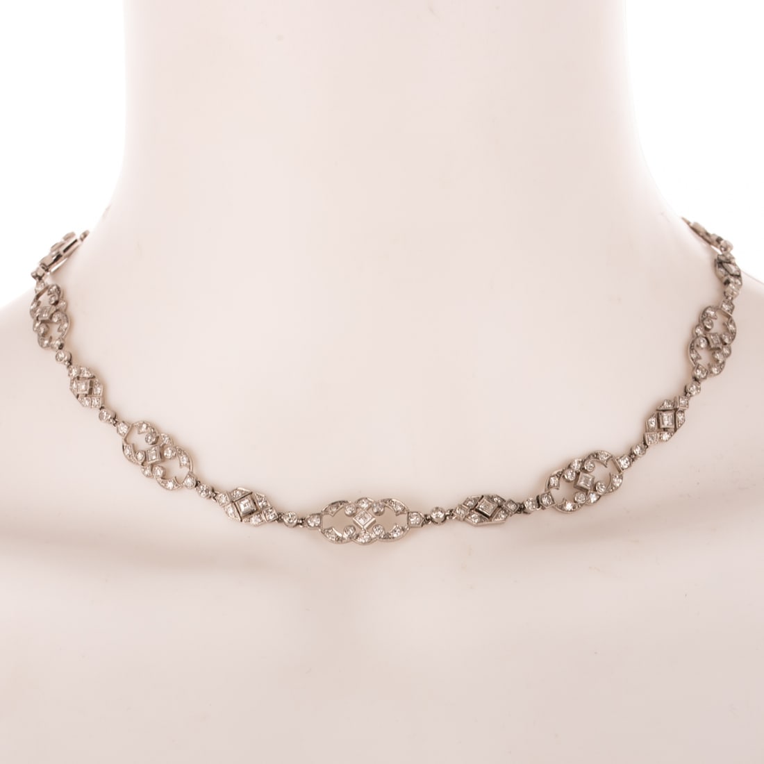 An Art Deco 10.00 ctw Diamond Necklace in Platinum: c.1920s platinum open work link necklace featuring Asscher cut diamonds and round diamonds weighing approx. 10.00 ctw with an average color grade of H - I and an average clarity grade of VS, bezel and