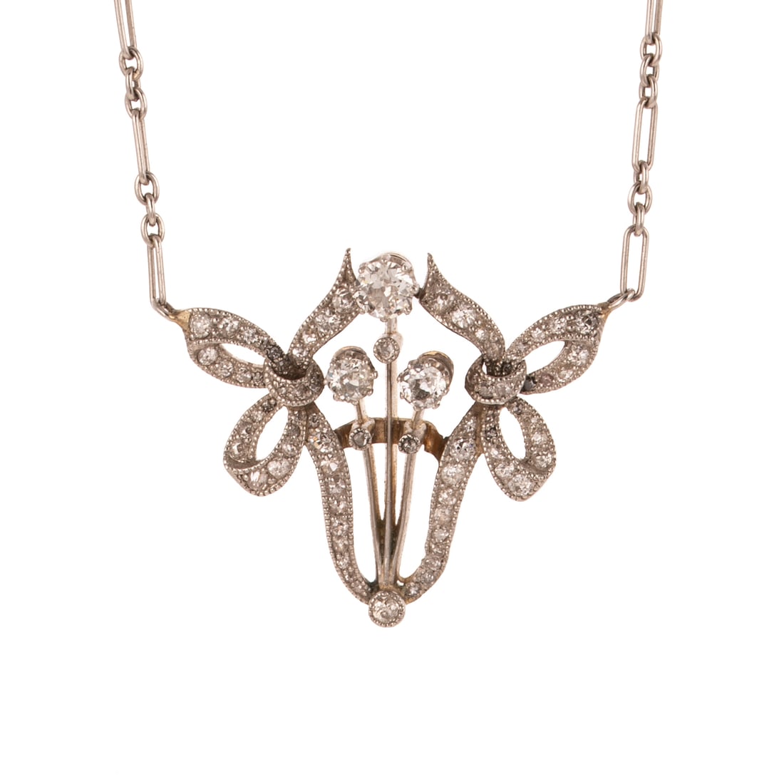 An Edwardian Diamond & Pearl Necklace in Platinum & 14K: c.1900s, Platinum topped 14K yellow gold pendant necklace featuring a trio of stems surmounted by diamond blossoms, between two ribbons with Old European and Old Mine diamonds weighing approx. 0.80 ct