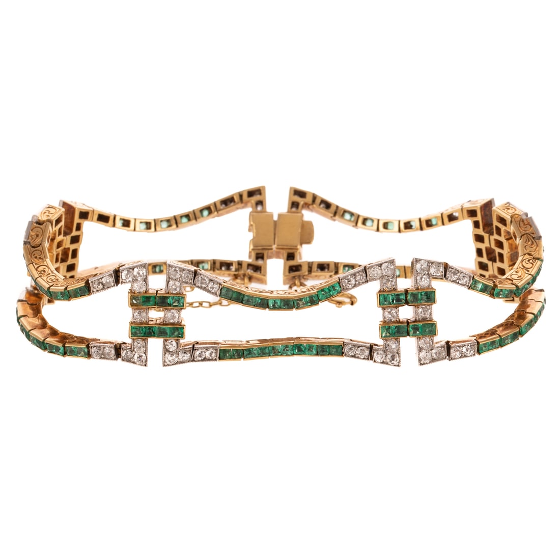 An Art Deco Fluid Diamond & Emerald Bracelet in 18K: c.1920s, 18K yellow gold flexible link bracelet featuring channel set very fine well matched emeralds weighing approx. 2.75 ctw with Old European cut diamonds weighing approx. 2.00 ctw, scroll engravi