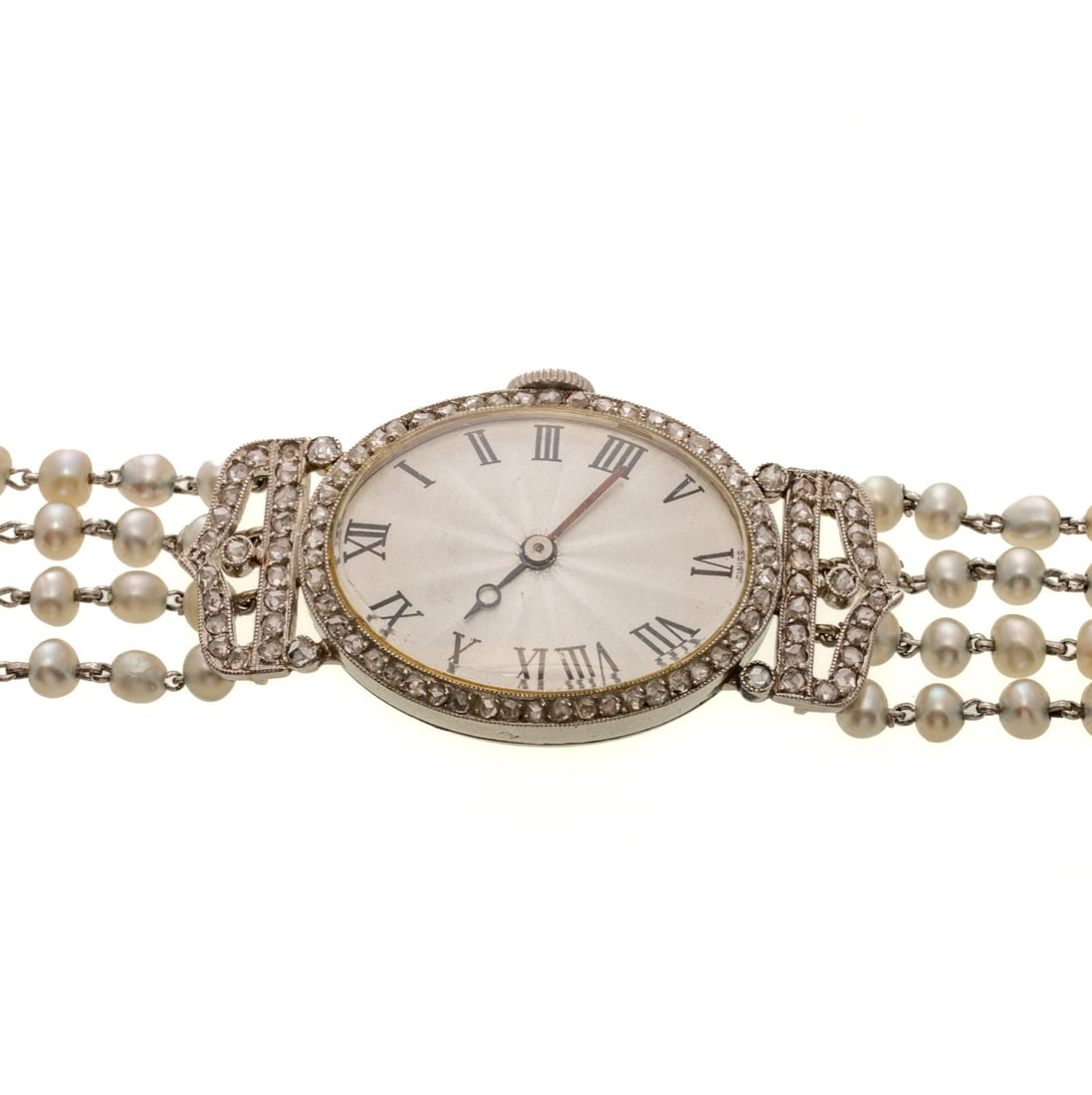 A Late Edwardian French Diamond & Pearl Dress Watch in Platinum: c. 1910s, French platinum dress wrist watch, the oval silvered guilloche dial with Roman numerals, rose cut diamond bezel and shoulders, milgrain accent and four strand seed pearl bracelet with diamon