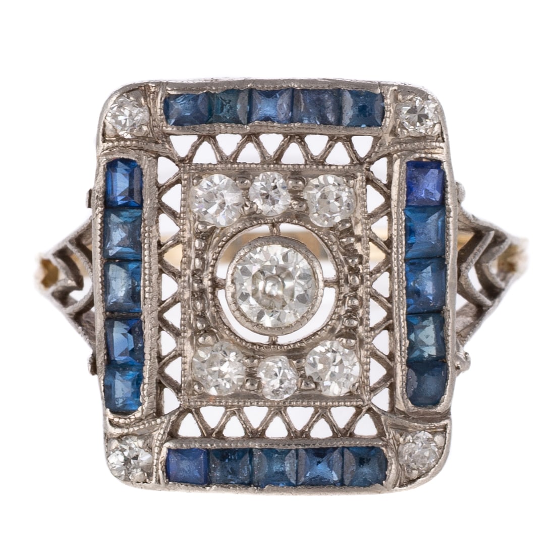 An Art Deco Diamond & Sapphire Filigree Ring in Platinum: c.1910s, platinum ring featuring an Old European cut diamond in the center weighing approx. 0.25 carats with additional diamond set in intricate filigree setting and channel set sapphires set into out