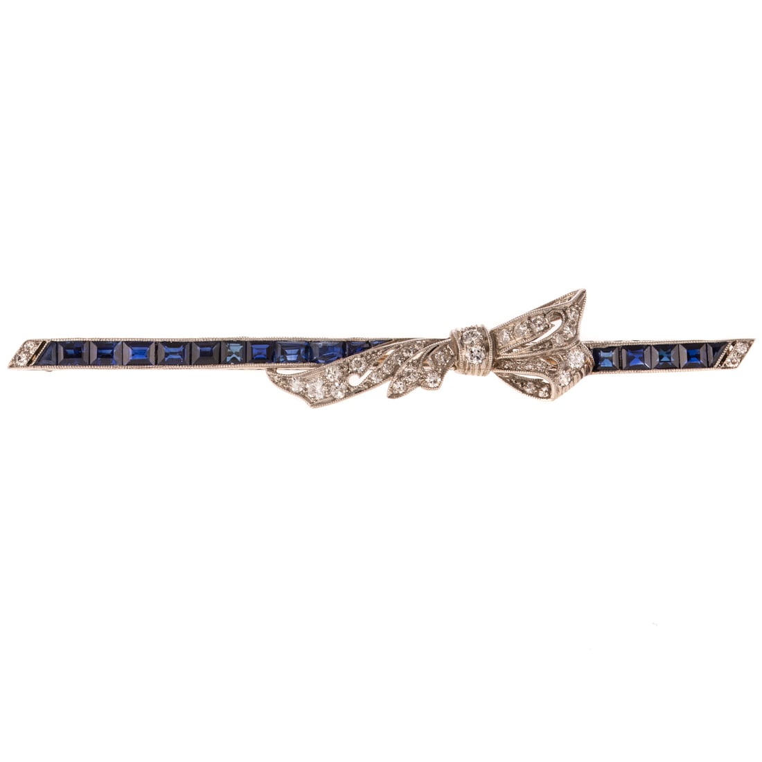 An Art Deco Sapphire & Diamond Bow Bar Pin in Platinum: c.1910s, platinum bar pin featuring very fine well matched royal blue calibre cut synthetic sapphires weighing approx. 1.50 ctw with diamonds set into the bow design, milgrain accent, 3 in. L, 7.8 gra