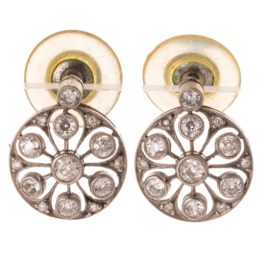 A Pair of Antique Diamond Cluster Earrings in Platinum: Platinum earrings featuring Old European cut diamonds weighing approx. 0.80 ctw with an average color grade of J - K and an average clarity grade of VS2 - SI1, bezel and bead set into open flower desi