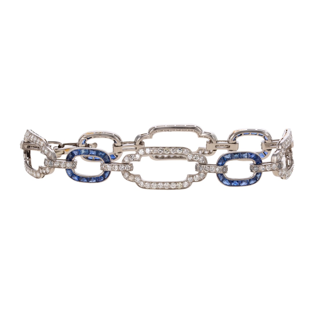 An Art Deco Diamond & Sapphire Open Link Bracelet in Platinum: c.1910s, platinum open geometric link bracelet featuring diamonds in larger links weighing approx. 1.80 ctw alternating with French cut vibrant blue sapphires weighing approx. 1.50 ctw, milgrain accen