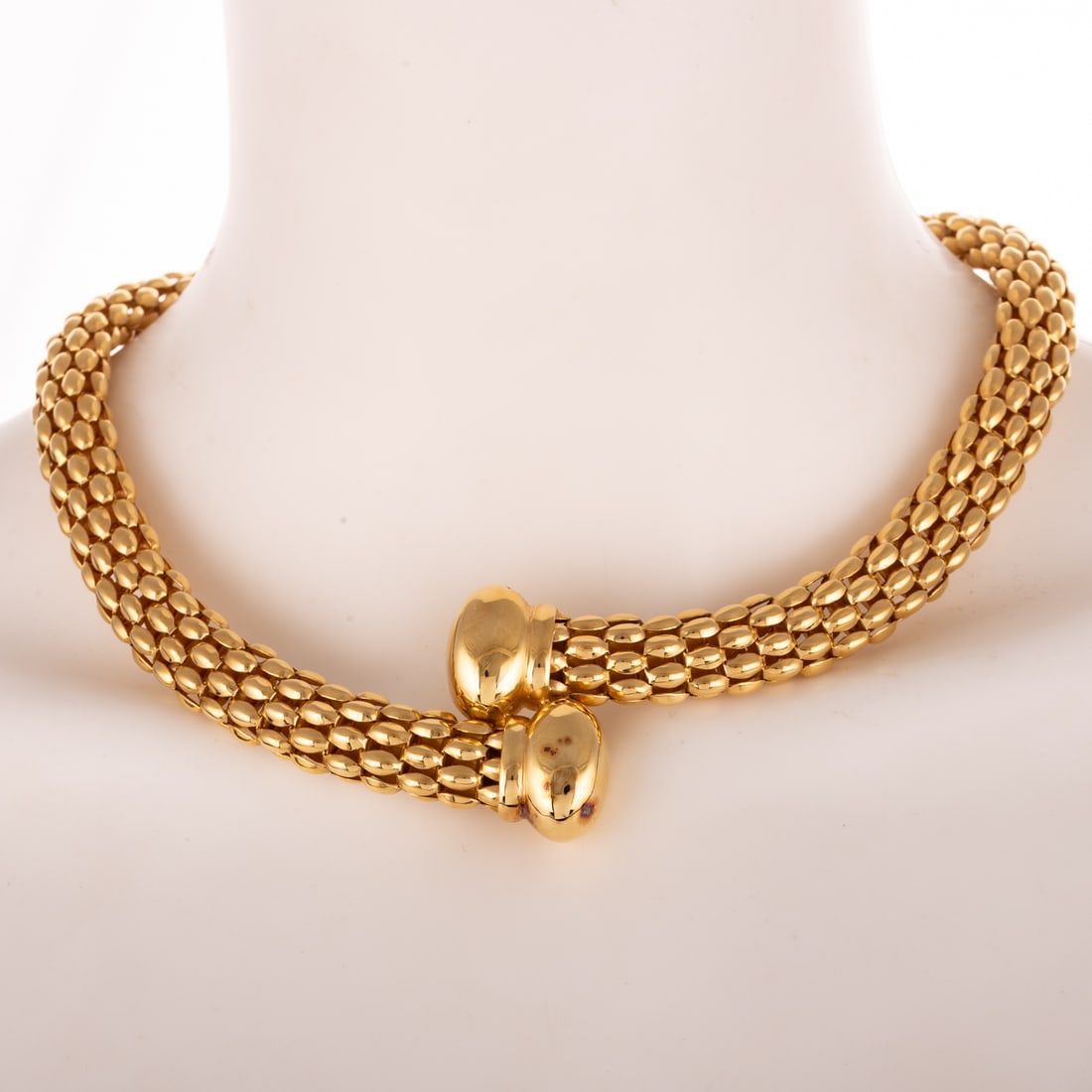 A Statement Mesh Bypass Necklace in 18K: 18K yellow gold tubular mesh bypass necklace with high polish end caps, hidden box clasp in the back, 1/2 in. W, 18 in. L, 106.1 grams Provenance: From the private collection of a prominent
