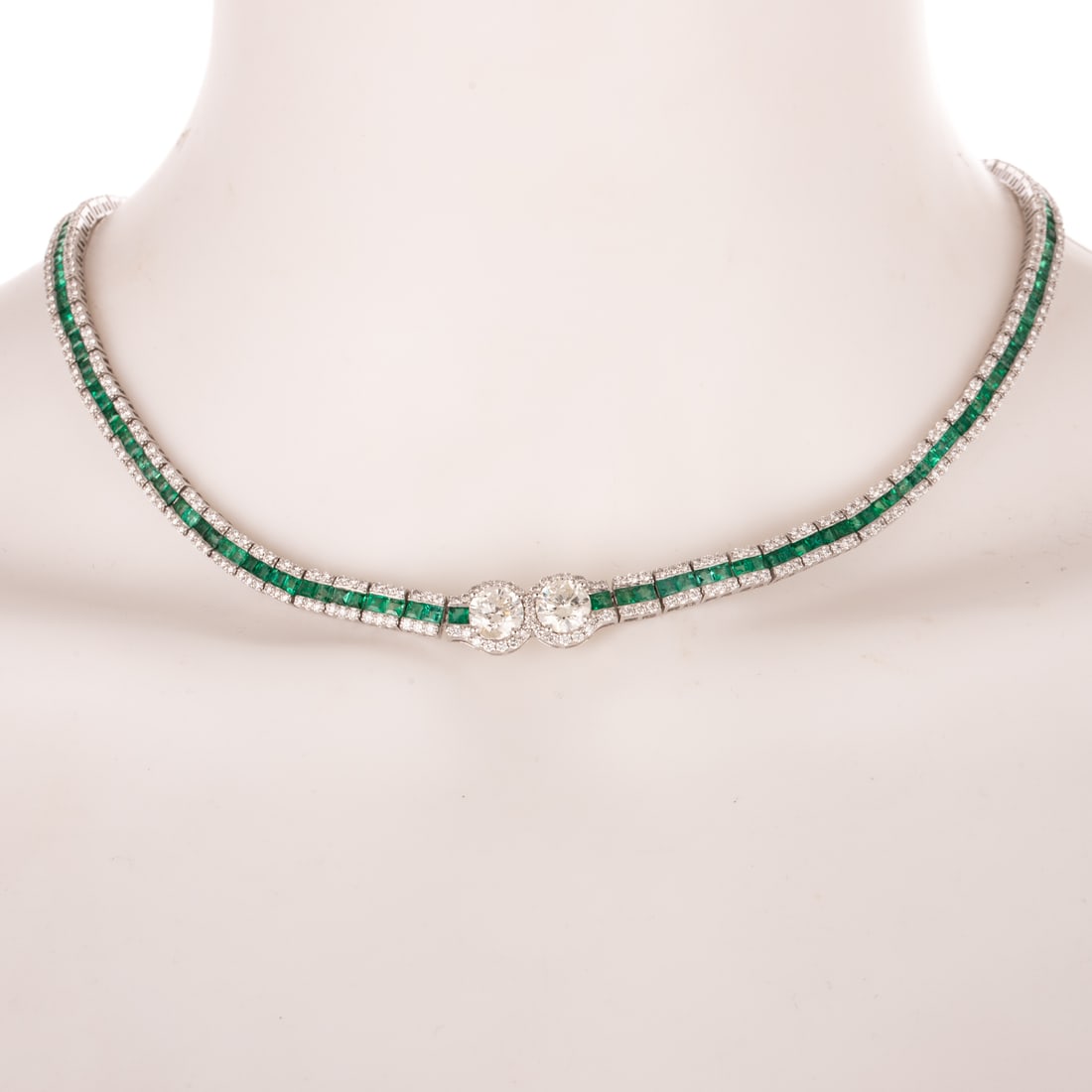 An Important Diamond & Emerald Line Necklace in Platinum: Platinum necklace by Oscar Friedman featuring two round diamonds weighing approx. 2.75 ctw with an average color grade of I - L and an average clarity grade of SI - I centrally prong set in the center
