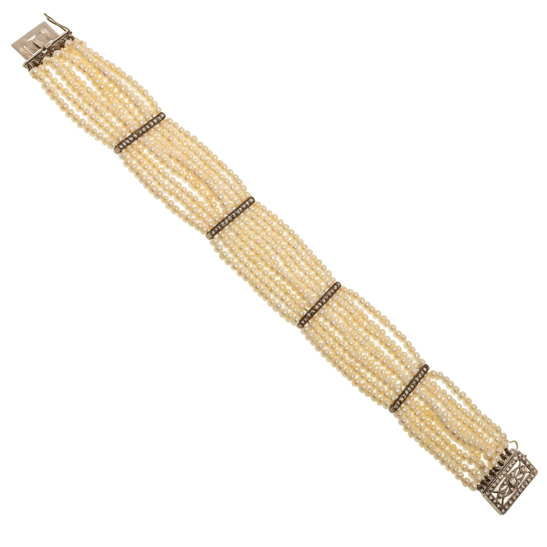 An Antique Seed Pearl & Diamond Bracelet in 14K: 14K white gold, platinum and sterling silver bracelet featuring nine strands of white seed pearls with rose cut diamond bead set spacers, filigree box clasp featuring a round diamond bezel set with