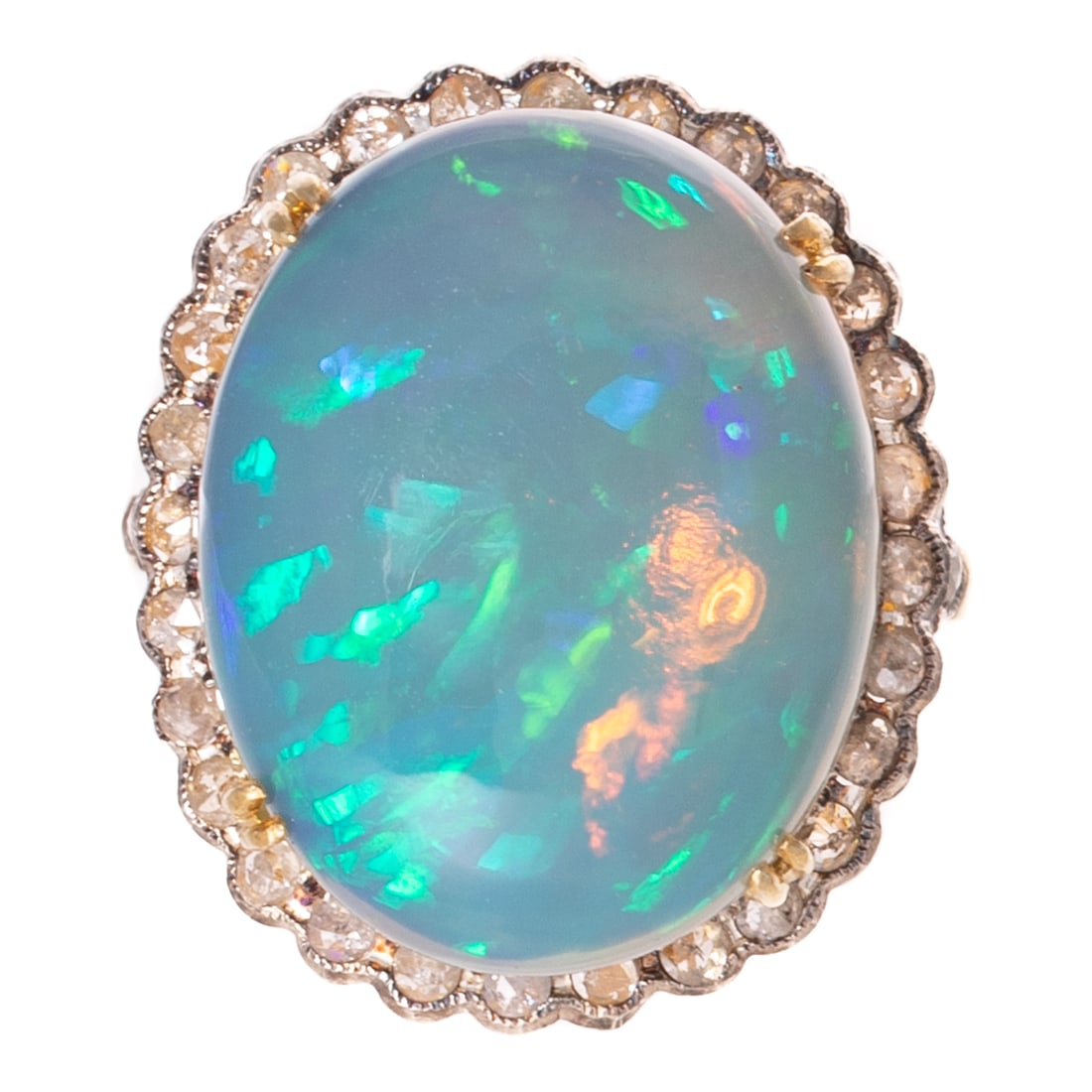 An Opal & Diamond Cocktail Ring in Vermeil: Vermeil and sterling silver cocktail ring featuring an oval cabochon opal 20.5 x 16.2 mm with blue, green and orange play-of-color, prong set and with a halo of rose cut diamonds extending to