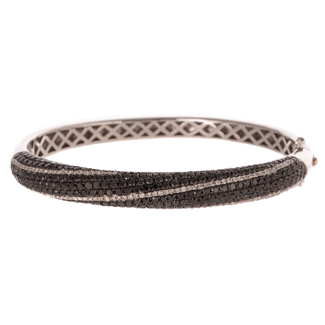 A Black & White Diamond Bangle in 14K: 14K white gold oval hinged bangle bracelet by Adamor, featuring pave set black and white diamonds in a spiral design across top of bangle, approx. 2.00 ctw, hidden box clasp with double safety latch,