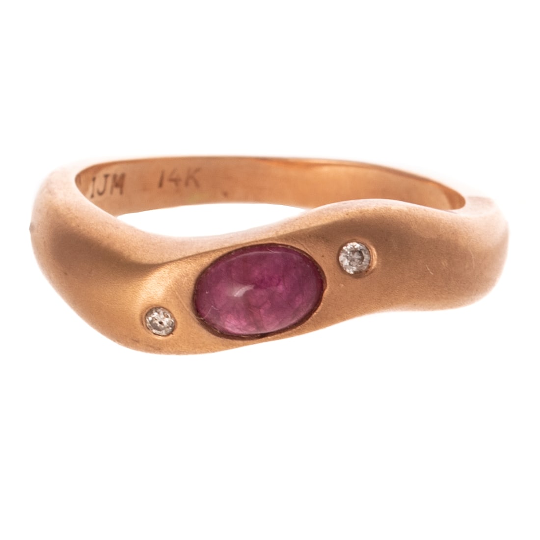A Modern Ruby Cabochon & Diamond Ring in 14K: 14K rose gold ring featuring a oval shaped ruby cabochon bezel set between two askew round diamonds flush set, sandblasted setting, high polish finish, signed "IJM," sz 7 3/4, 5.2 grams