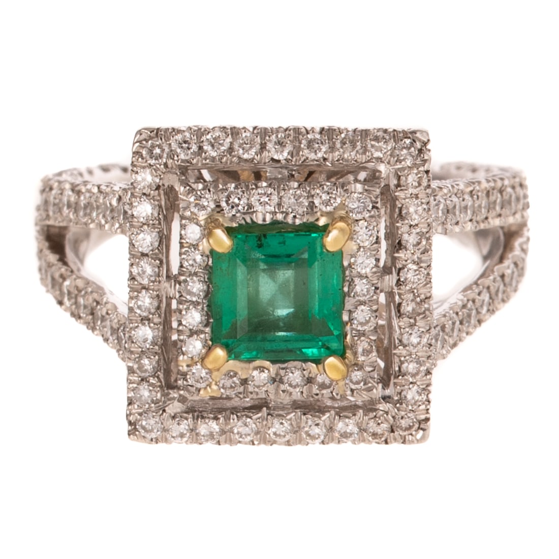A Double Halo Emerald & Diamond Ring in Platinum: Platinum ring by Baroka featuring a square step cut emerald weighing approx. 0.80 carats set in 18K yellow gold prongs with diamond double halo and open split shank approx. 1.50 ctw with an average co