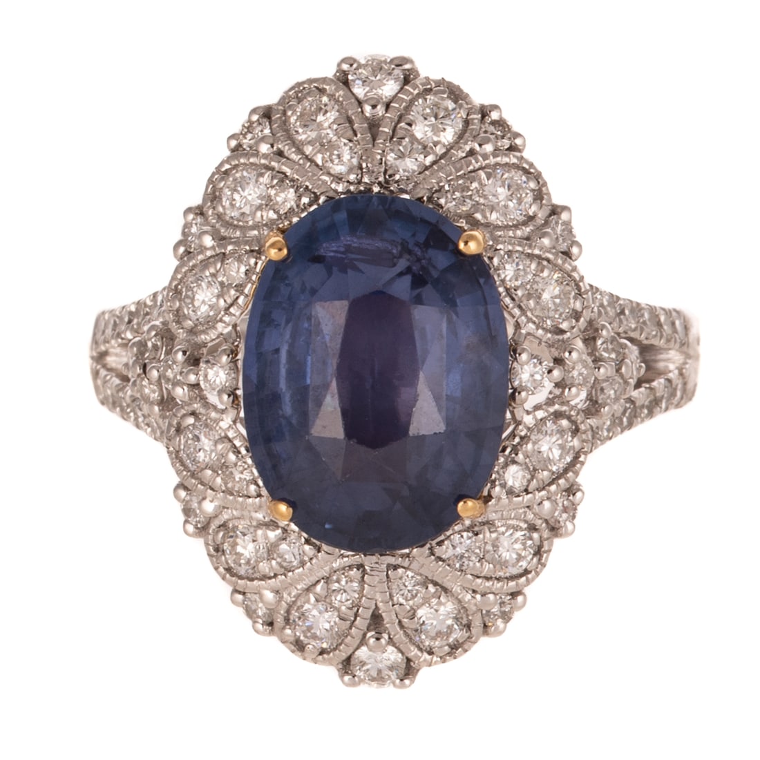 A GIA 4.74 Ceylon Color Change Sapphire & Diamond in Platinum: Platinum ring by Otto Gottieb featuring an oval shaped color change Ceylon sapphire with color change from violetish blue to purple weighing 4.74 carats, accompanied by GIA Gemological Report