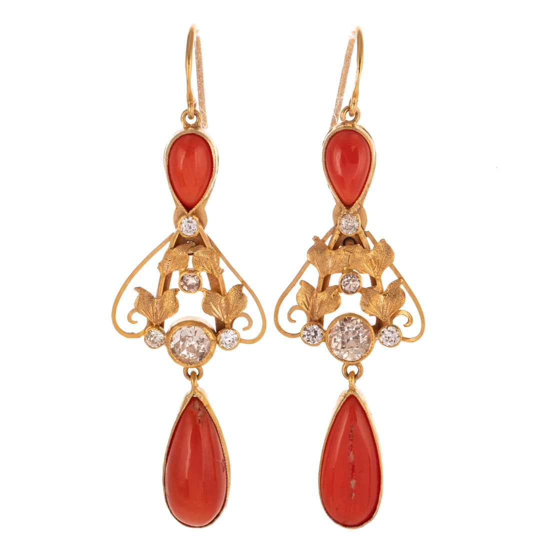 A Pair of Victorian Diamond & Coral Earrings in 9K: Antique 9K yellow gold earrings featuring pear shape coral cabochon bezel set above and below Old European diamonds weighing approx. 0.90 ctw bezel set amid high polish and textured scrolling gold fol