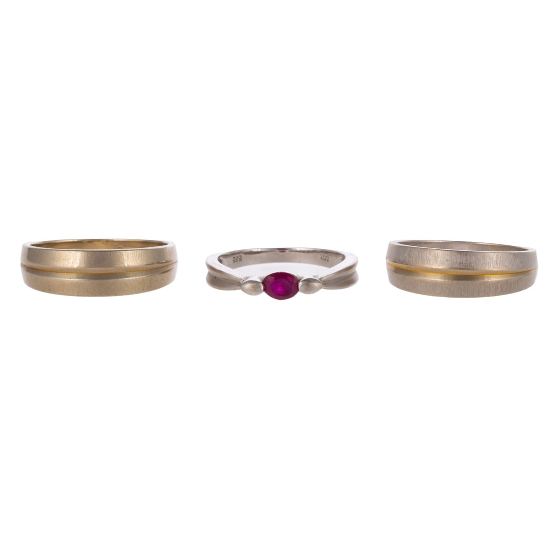 A Ruby Ring & Two Concave Bands in 14K: 1) 14K white gold ring featuring an oval shaped ruby measuring approx. 4.6 x 3.8 mm prong set, concave matte and high polish shank, sz 6.5, and 2) A pair of 14K white gold bands with yellow concave