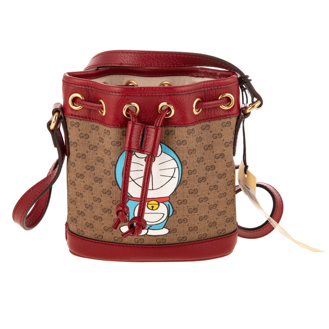 A Gucci Ltd. Ed. x Doraemon Mini Bucket Crossbody: A coated canvas Gucci Ltd. Ed. x Doraemon Mini Bucket Crossbody with gold tone hardware and red leather trim. Canvas lining and adjustable leather shoulder strap. Includes dust bag, care