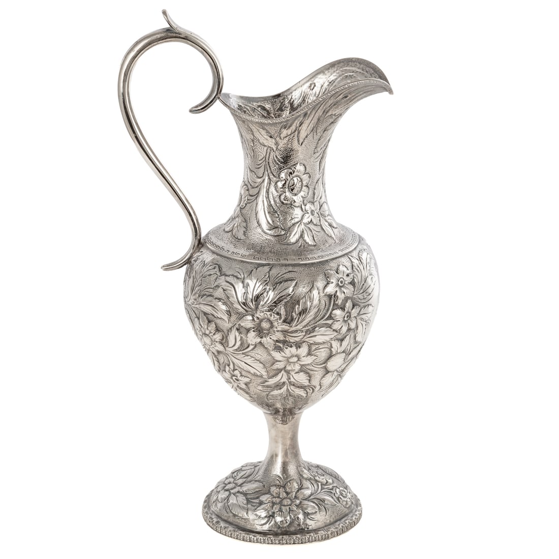 Baltimore Sterling Repousse Armorial Ewer: Late 19th century, unmarked, possibly S Kirk & Son, urn-form, on a pedestal foot, with floral and foliate repousse decoration allover, against a stippled ground, trailing acanthus under the spout,