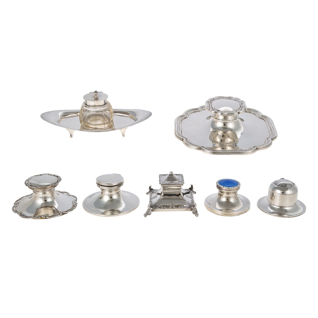 One Victorian & Six George V Silver Inkwells: Including: 1) Lee & Wigfull, Sheffield, 1899, square with shell decoration, 2 3/8 in. H, 2.1 ozt.; 2) Henry Matthews, Birmingham, 1911, oval standish with sterling-mounted glass inkwell, 2 3/4 in. H