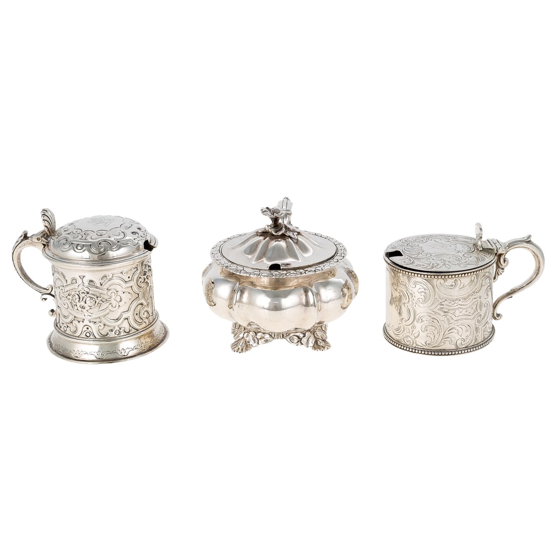 Three Victorian Silver Mustard Pots: Including: 1) Cylindrical, with chased scrolling foliage allover, the cover with a chased armorial, cobalt glass liner, by Joseph Angell I & Joseph Angell II, London, 1838, 2 3/4 in. H overall, 4.2