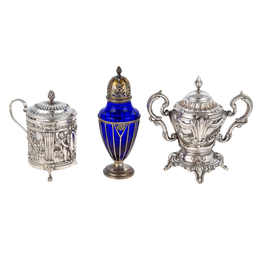 Three French Silver Table Pieces: Including: 1) An 18th century sterling mustard pot, crowned T and HP maker's mark, the cylindrical frame decorated with fruit and floral swags, and two putto flanking a monogrammed shield, with glass 