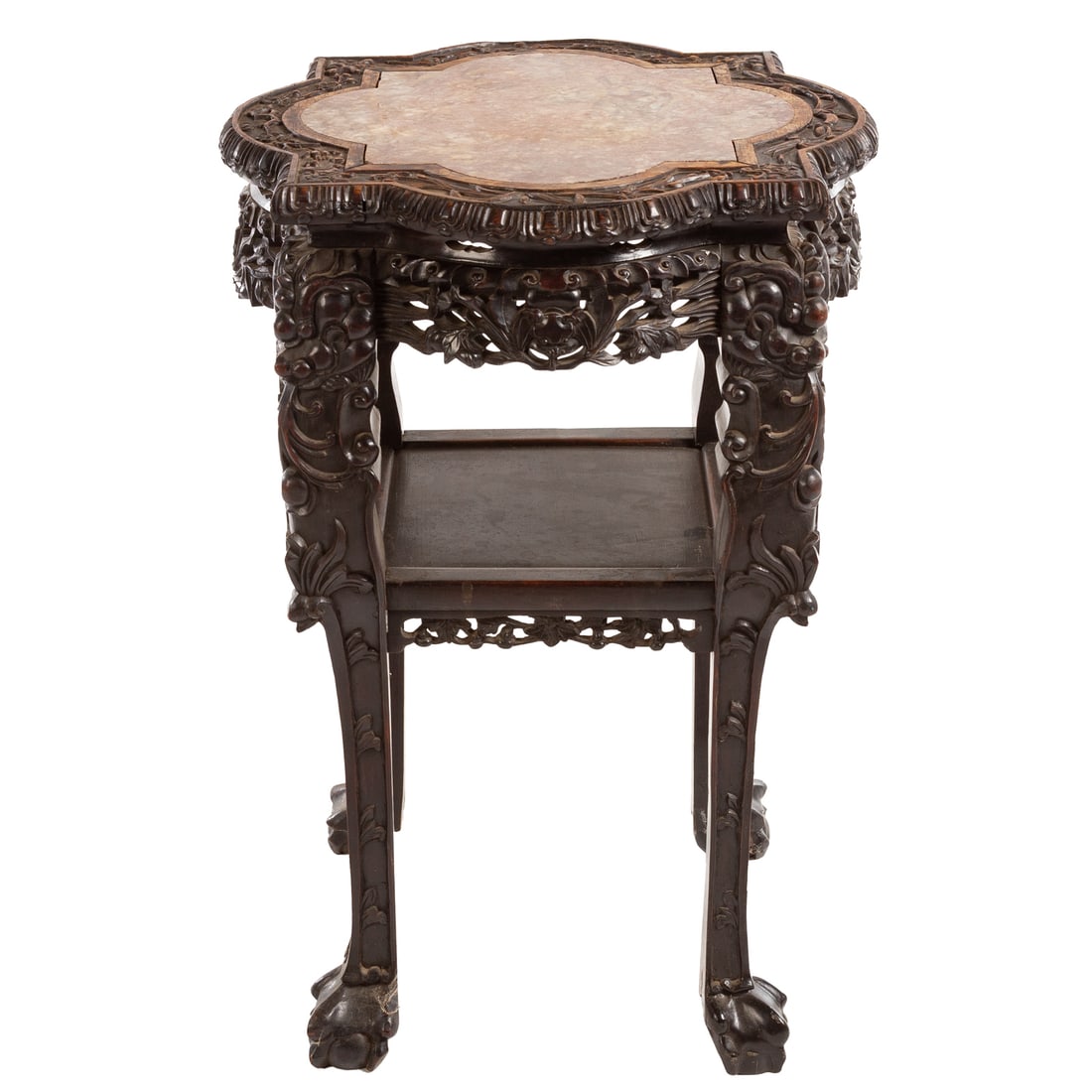 Chinese Carved Hardwood Marble Top Plant Stand: Quatrefoil shaped top with matching rose marble insert, carved apron extending into carved legs connected by an undershelf, 32 1/4 in. H, 22 in. Diam. Provenance: From the collection of a notable