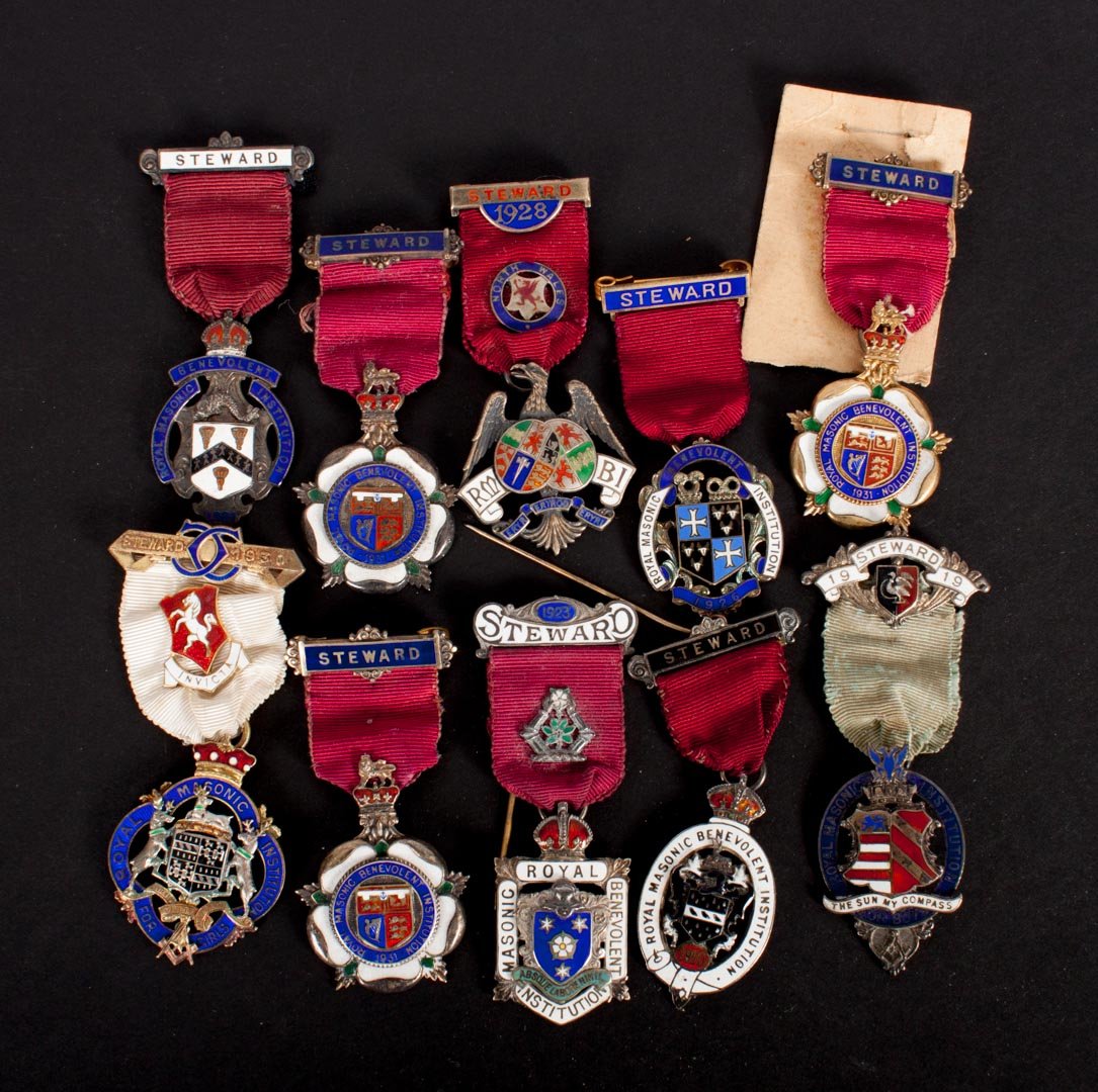 Ten British badges, Royal Masonic Benevolent Inst.: awarded to Stewards of the society, 1919-1931 (including three 1931) the medal for each year presenting a different armorial design; enamelled sterling silver, 6.85 ozt. t.w.