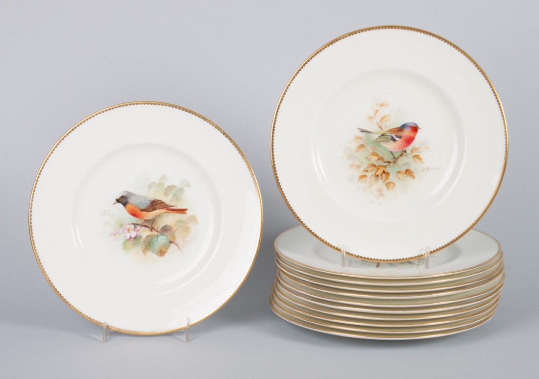 12 Royal Worcester bird-decorated cabinet plates: 20th century; each plate with central hand-painted decoration of songbird in tree, artist signed and bird identified on verso, 12 different birds, 9 in. Diam.
