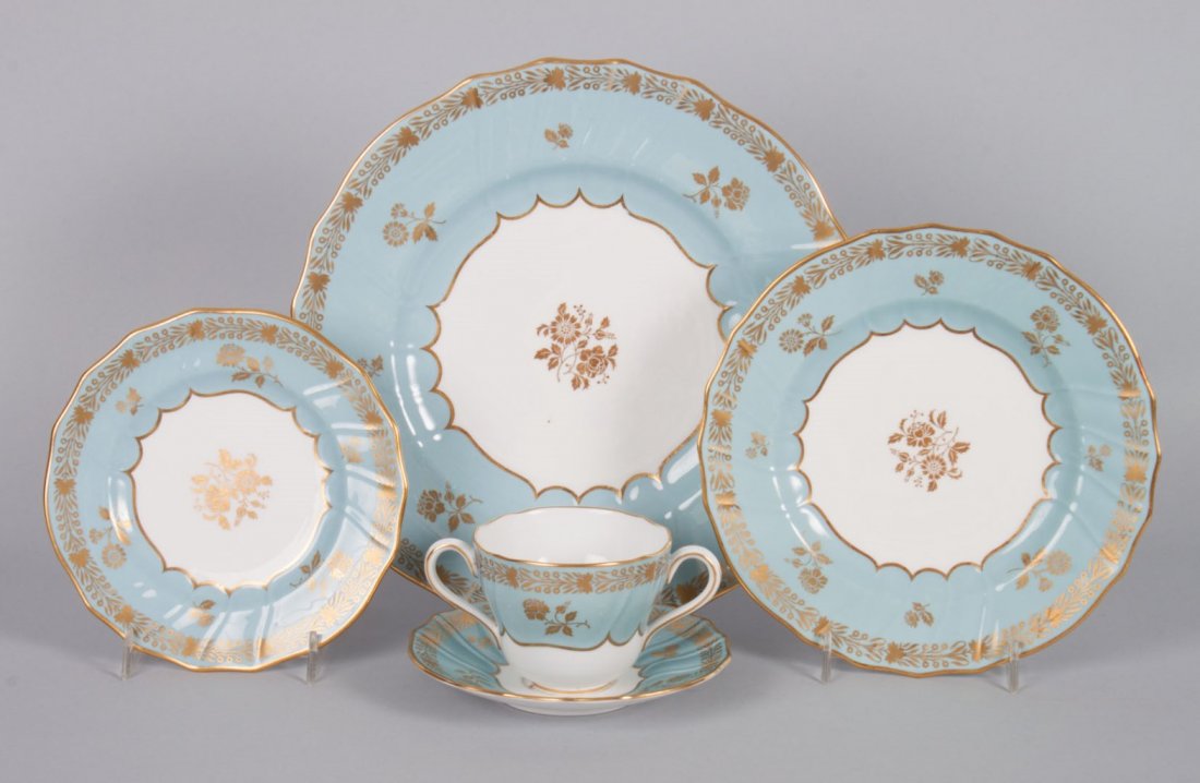 Copeland Spode china partial dinner service: second half-20th century; 84 pieces, comprising: 12 luncheon plates, 12 bread plates, 12 teacups, 12 bouillon cups, 24 saucers, and 13 dinner plates; aqua ground with gilt floral decoration,