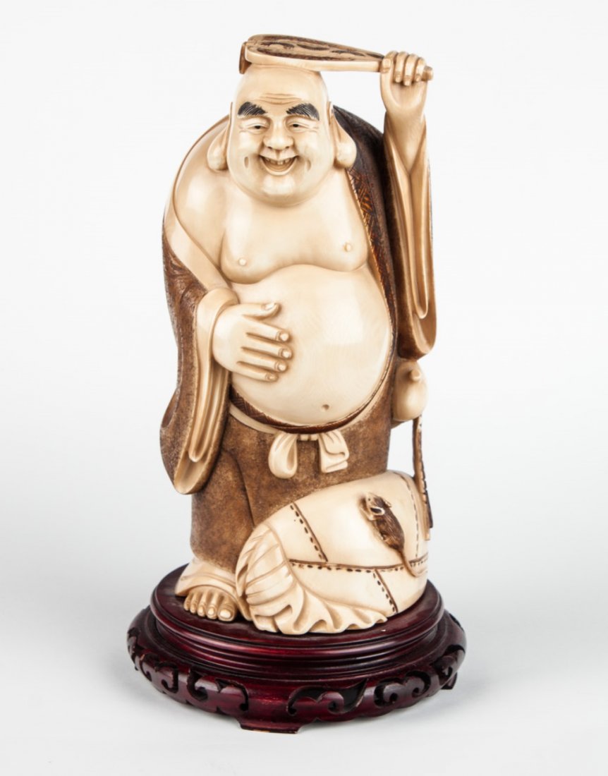 Japanese carved ivory Hotai: modeled as god of good luck with sack and rat, with brown ink highlights, mounted on wood base, 11 1/2 in. H.