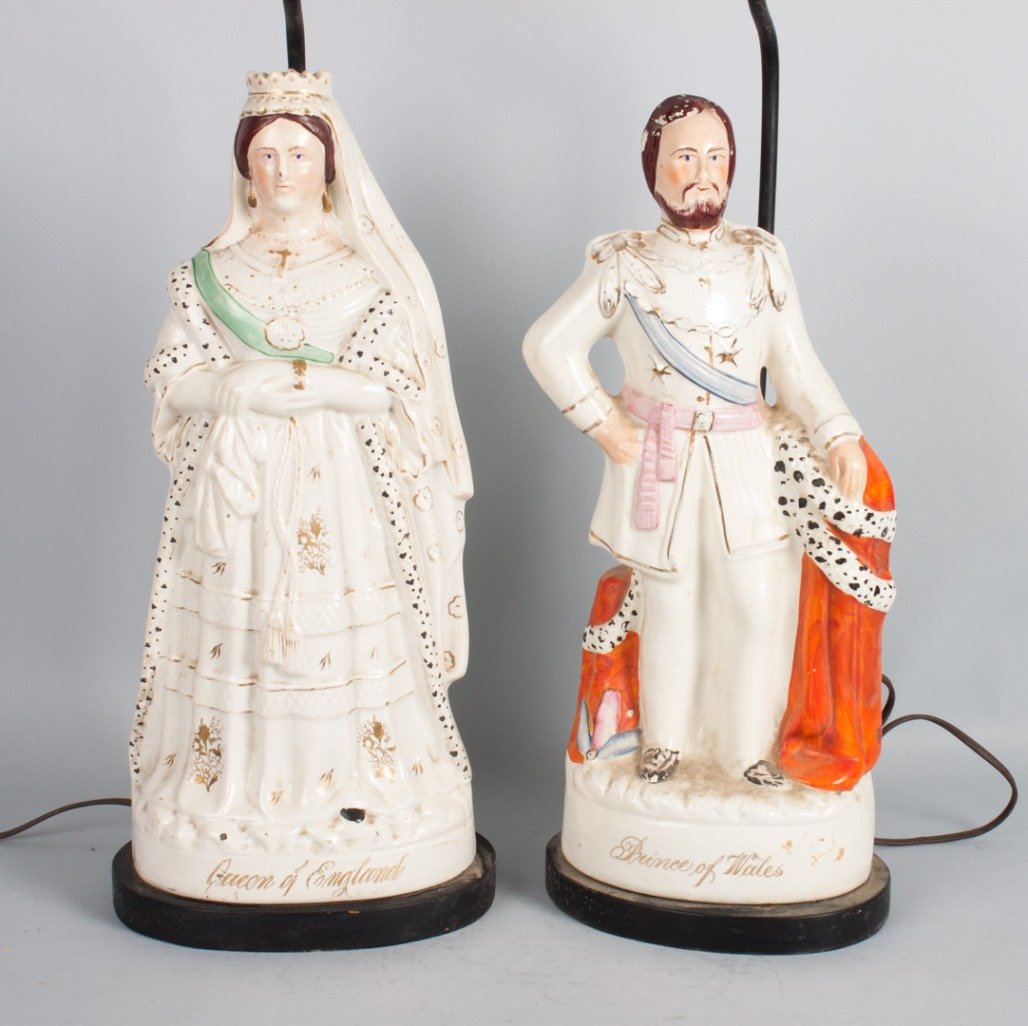 Staffordshire Victoria and Albert lamps: mid-19th century; painted and gilt highlighted figures, with title "Prince of Wales" and "Queen of England" on bases, mounted on ebonized wood lamp bases, approx. 17 in. for figures, 31 in. H. total