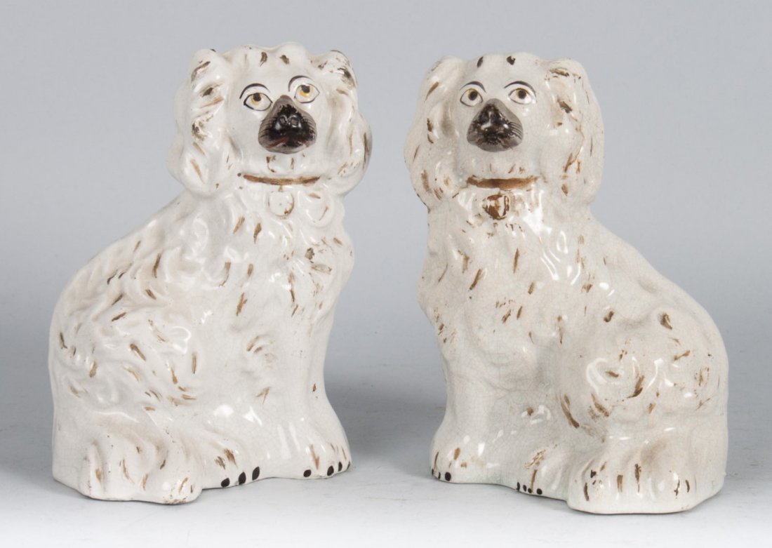 Pair of Staffordshire King Charles spaniels: mid-19th century; glazed earthenware with paint and parcel-gilt highlights, 6 in. H.
