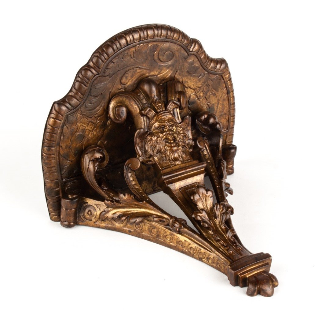 Renaissance Revival bronze wall bracket: shaped shelf with acanthus and scroll supports, with Northwind mask, 9 in. H., 8 in. W., 6 1/2 in. D.