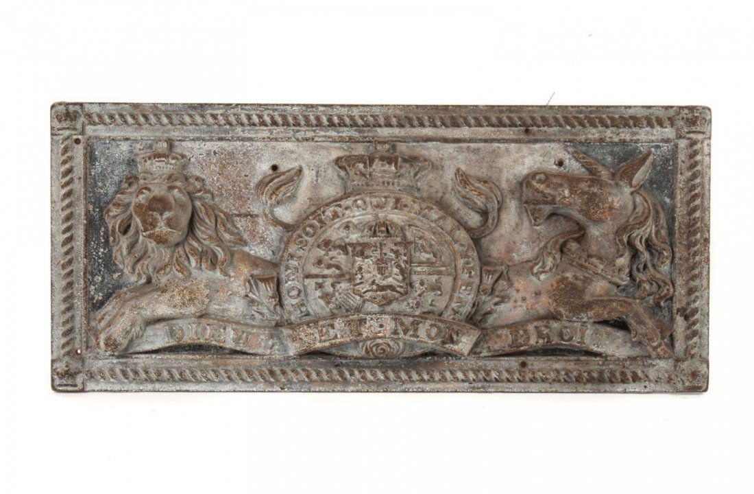 Cast iron armorial relief plaque: rectangular plaque with relief decoration of lion, heraldic shield, and unicorn with motto scroll, 15 1/2 in. H., 36 in. L.