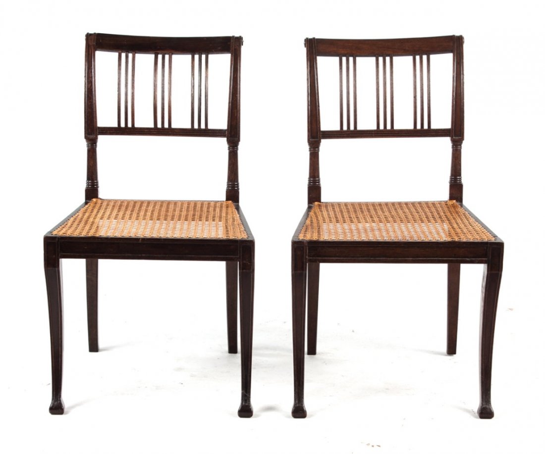 Four Regency mahogany caned seat side chairs: circa 1815; reeded vertical splats, sabre legs, 33 in. H., 19 in. W.