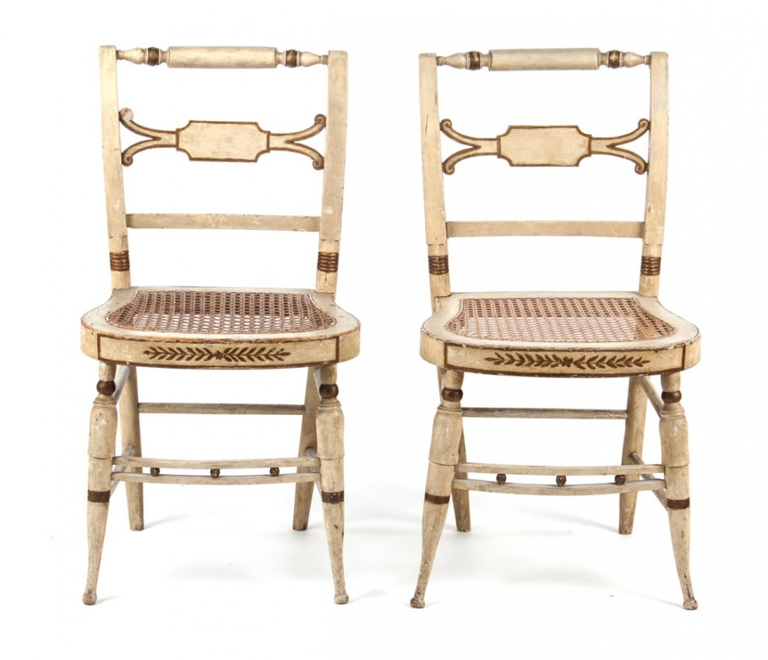 Three American Classical painted wood side chairs: New York, circa 1825; rolling pin crest rails, caned seats, round turned legs connected by double stretchers, painted wood with gilt highlights, 33 in. H., 17 1/2 in. W.