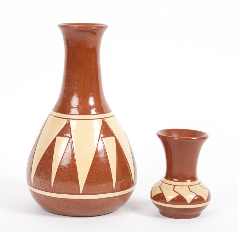 Two Pine Ridge Sioux glazed ceramic vases: large vase with stylized geometric pattern band by Olive Cottier, signed "O. Cottier, Pine Ridge Sioux," with mountain and tree mark, 8 1/4 in. H., and miniature vase with stylized geometric band by E