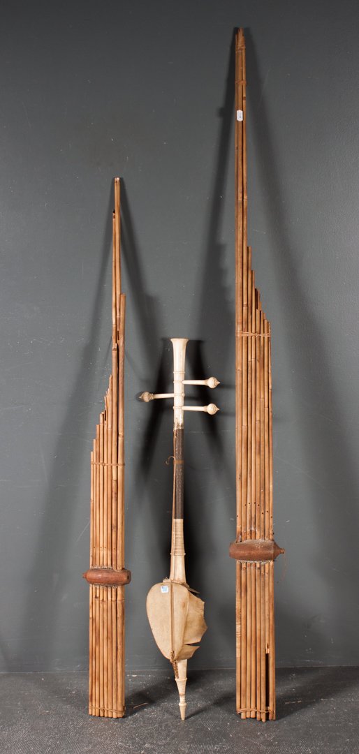 Thai saw sam sai three-string violin: late 19th century, constructed of turned ivory, chased brass, gourd, and rawhide; about 39 in. L.; together with two Southeast Asian reed pan-pipes