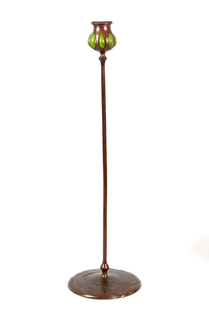 Tiffany bronze and favrile glass candlestick: first half-20th century; patinated bronze base, shaft, and bobeche with favrile glass inserts, impressed ""Tiffany Studios New York 28985," 20 in. H., 5 1/2 in. Diam. of base