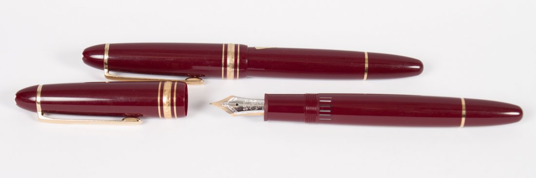 Two Montblanc Meisterstuck fountain pens: burgundy cases