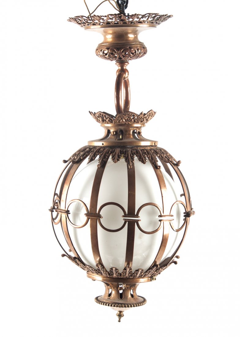 Victorian style copper hanging light fixture: early 20th century; spherical pierced copper light fixture, with milk glass globe, approx. 28 in. L.