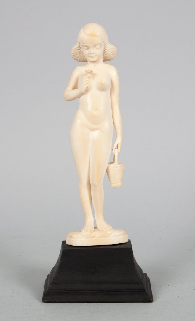 Indian carved ivory female nude: modeled as young girl holding flower and flower basket, mounted on ebonized wood base, 8 1/2 in. H.