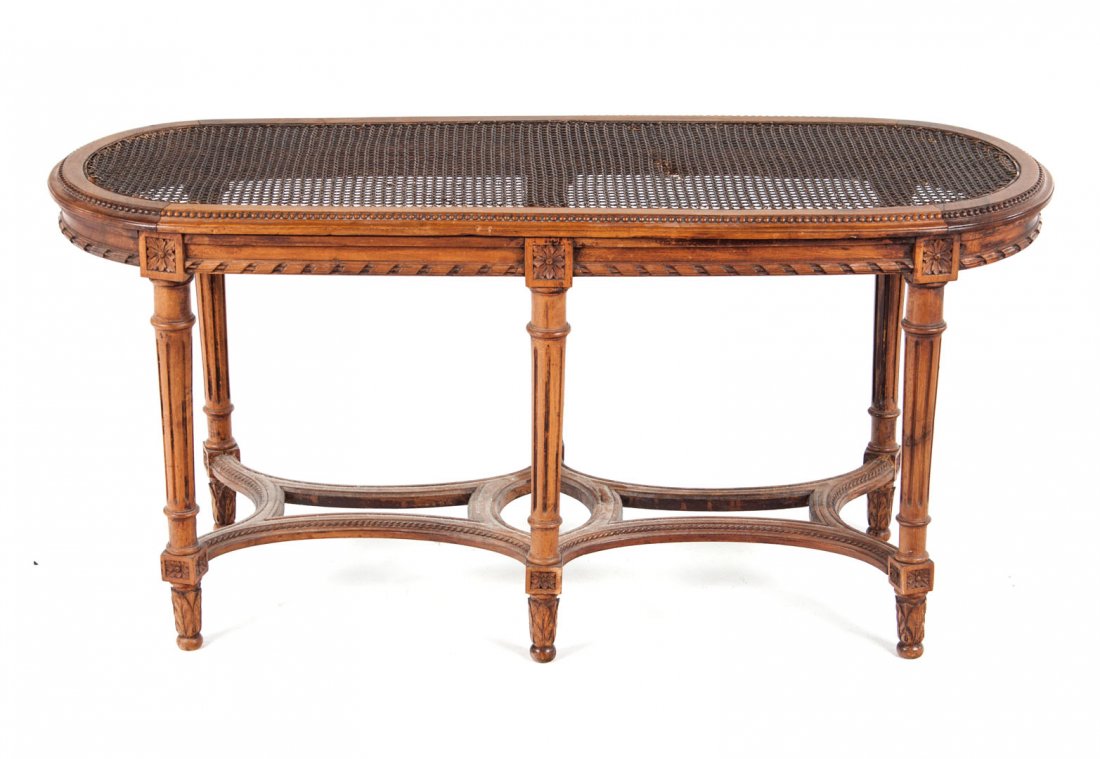 Louis XVI style fruitwood cane seat window bench: oval form with six turned legs with stretchers, 20 in. H., 2 in. L., 16 in. W.