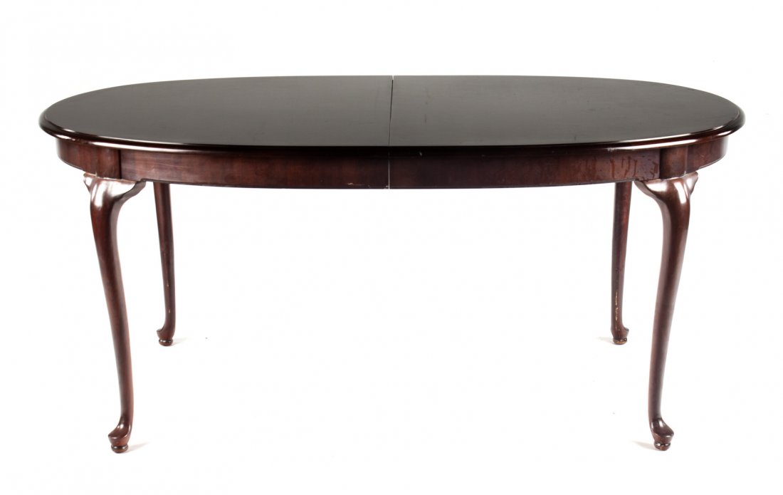 Queen Anne style mahogany dining table: Thomasville Furniture; 29 in. H., 68 in. L., 44 in. W., with two 20 in. extension leaves