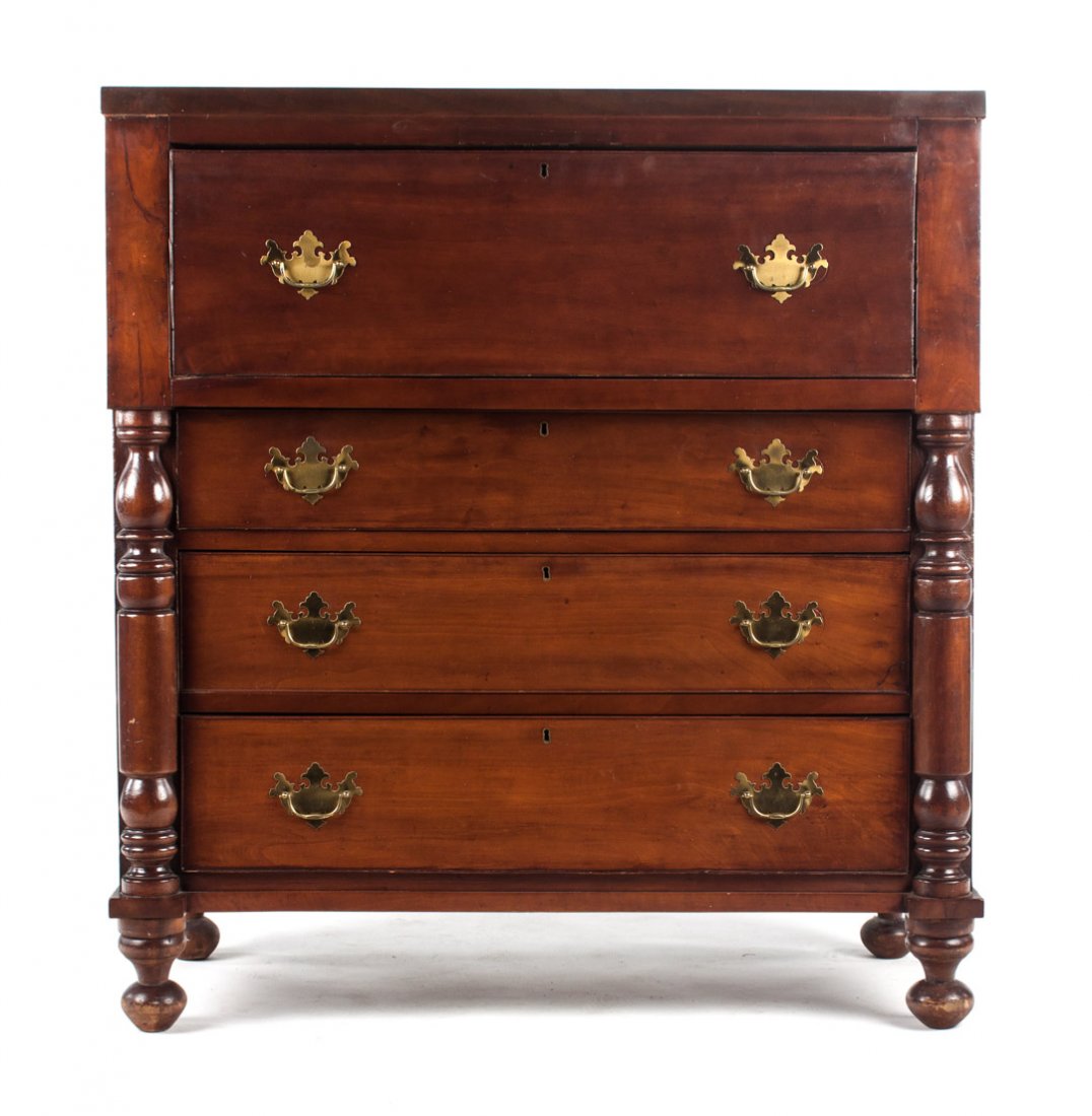 Federal mahogany butler's desk: circa 1825; top drawer opens to reveal fitted interior, three graduated drawers with half-turned column supports, and ball feet, 46 in. H., 43 in. W., 20 in. D.