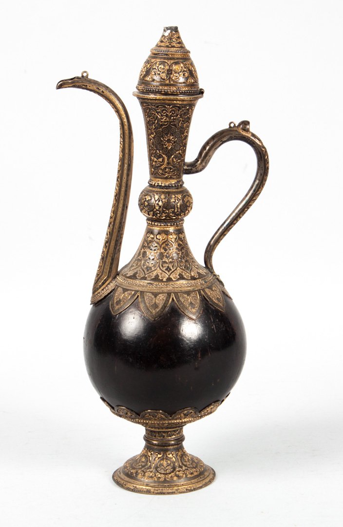 Russian arabesque style silver and coconut teapot: late 19th century, comprising a polished coconut shell mounted with heavily-chased niello enamel and gilt silver mounts; maker's mark transliterated "FR," no other hallmarks apparent; 12 7/8 in. H., 1