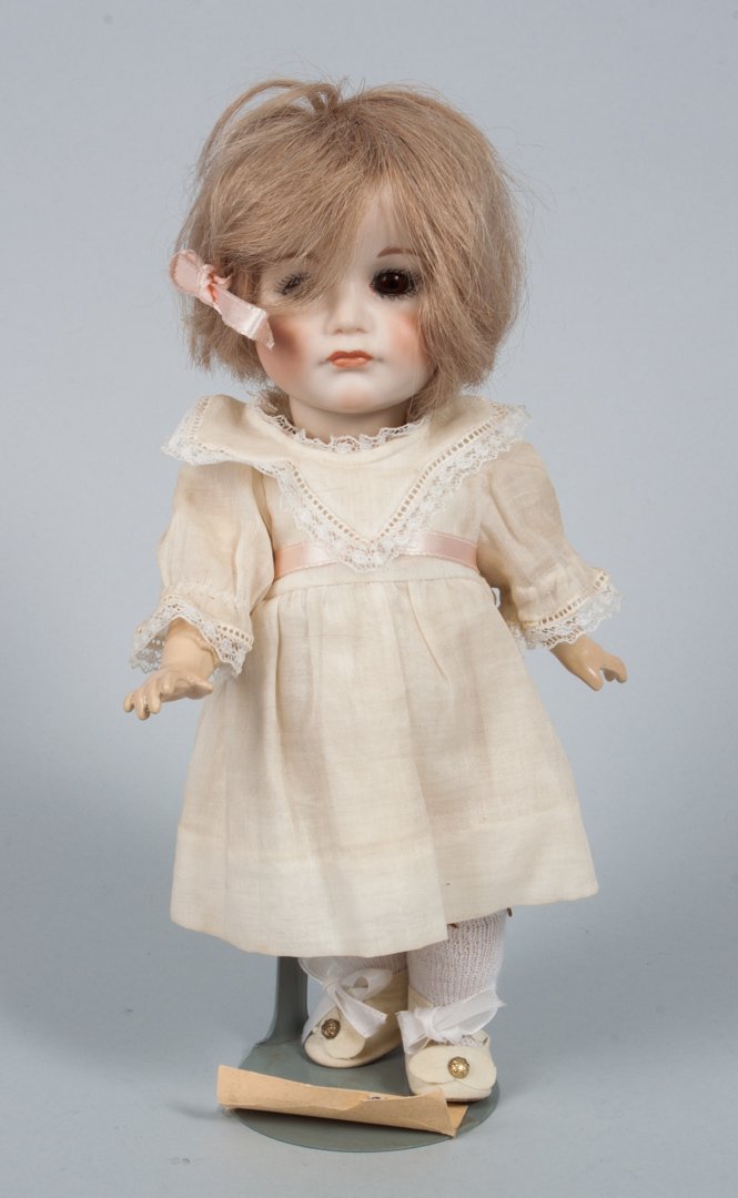 Kammer & Reinhardt bisque & composition doll: first quarter-20th century; doll in lace-trimmed dress with leather shoes, impressed mark on back of head, approx. 10 in. H.