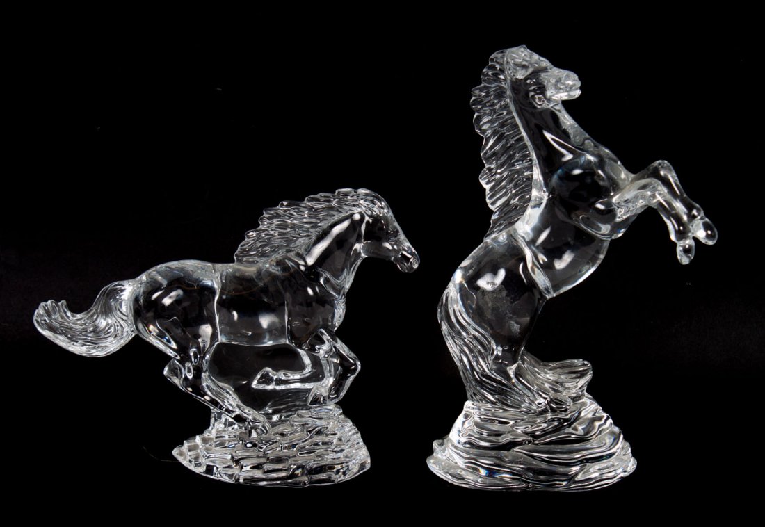 Two Waterford crystal horses: rearing horse and galloping horse, each on rocky base with acid etched marks, 6 and 9 in. H.