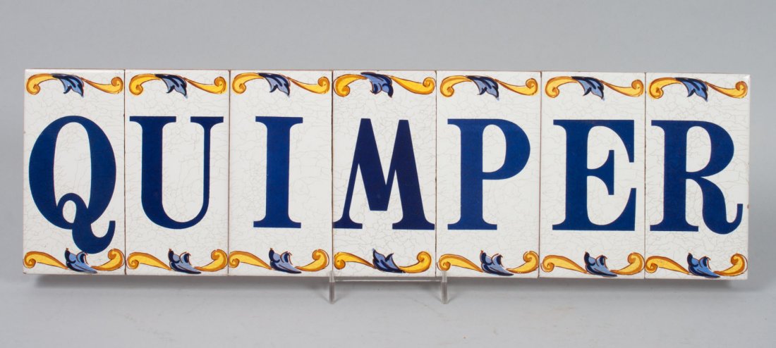 Quimper faience tile sign: seven scroll bordered letter tiles spelling out "QUIMPER," mounted on wood backing with hanger, 21 in. L., 6 in. W.