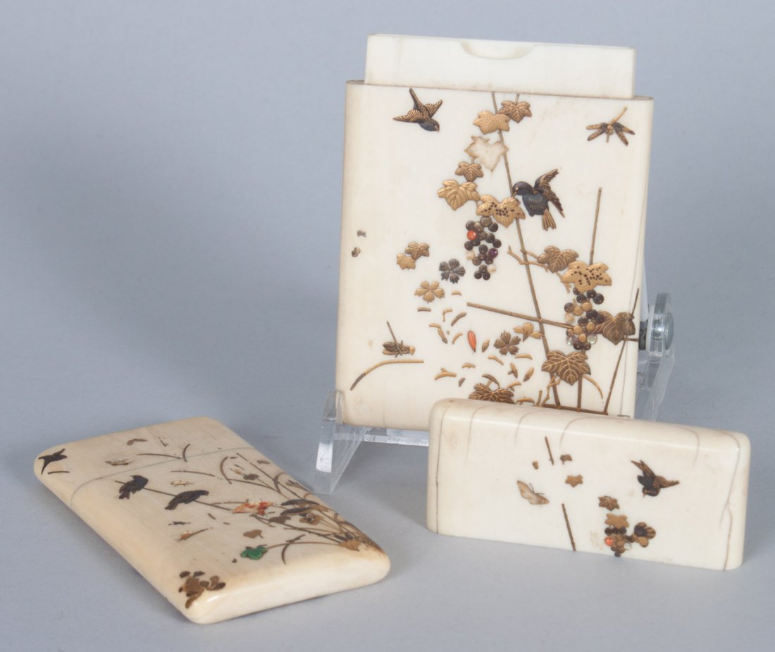 Two Japanese inlaid ivory cases: late 19th century; calling card case with inlaid gilt lacquered birds, insects, and flowers, 4 in. L., 2 1/2 in. W., and a needle case with similar decoration, 3 1/4 in. L., 1 3/4 in. W.