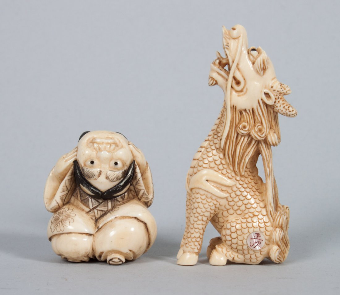Two Japanese carved ivory netsukes: Dragon and child with demon mask, 1 1/2 and 2 1/2 in. H.